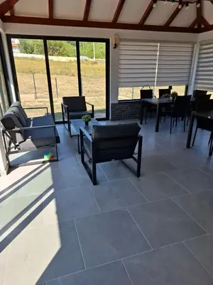 a patio with chairs and a table on a patio at Apartmani Luna, Borsko jezero in Bor