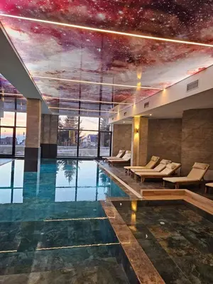a large swimming pool with a starry ceiling at Hop Na Kop Studio Apartman in Kopaonik