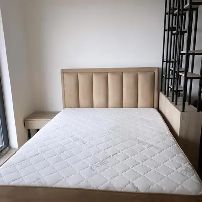 a bed in a room next to a staircase at Hop Na Kop Studio Apartman in Kopaonik