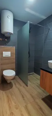 a bathroom with a toilet and a sink at Hop Na Kop Studio Apartman in Kopaonik