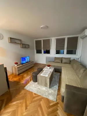 a living room with a couch and a tv at Studio Inn 