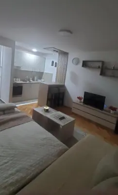 a living room with a couch and a table in it at Studio Inn 