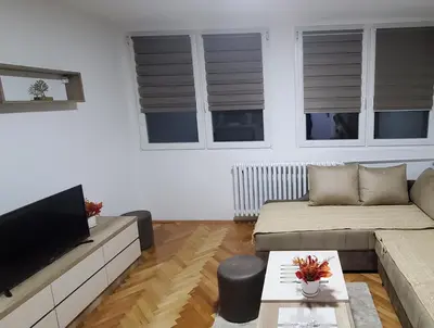 a living room with a couch and a flat screen tv at Studio Inn 