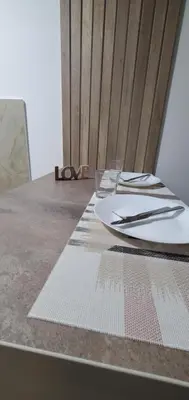 a table with a plate and a pair of glasses on it at Studio Inn 