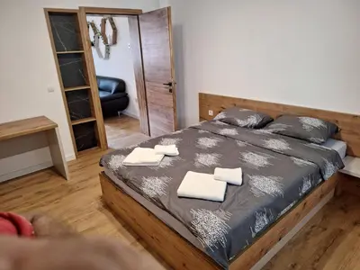 a bedroom with a bed with two towels on it at Apartmani Park Cuprija in Ćuprija