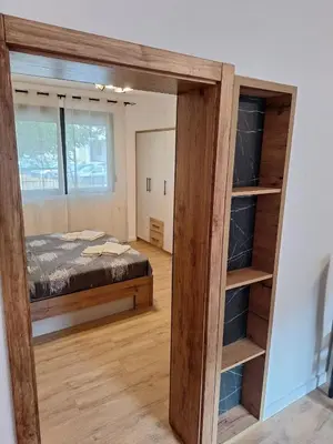 a room with a bed and a large mirror at Apartmani Park Cuprija in Ćuprija