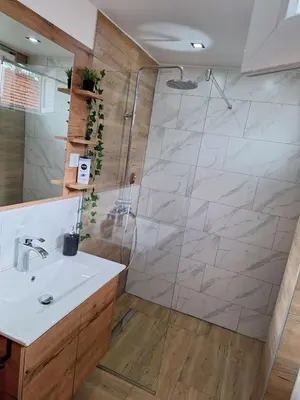 a bathroom with a sink and a shower at Apartmani Park Cuprija in Ćuprija