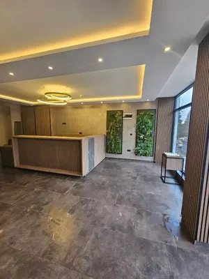 a large room with a lobby with a desk andwindows at Andromeda Apartment Residence Hill Kopaonik in Kopaonik