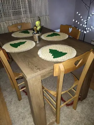 a wooden table with chairs and plates on it at Apartman Sweet Dreams in Svrljig