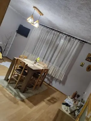 a room with a table in front of a window at Apartman Sweet Dreams in Svrljig