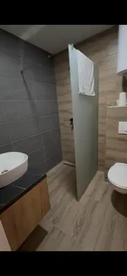 a bathroom with a white sink and a toilet at A10 Residence hill, Kopaonik in Kopaonik