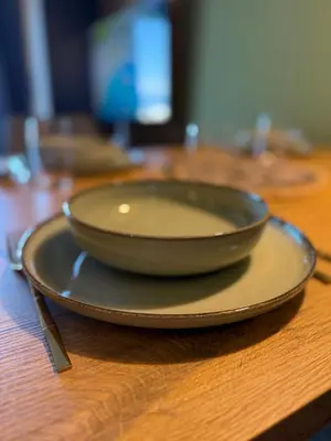 a bowl on a plate on a wooden table at A10 Residence hill, Kopaonik in Kopaonik