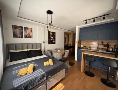 a bedroom with a bed with two yellow pillows on it at DUNjA Apartman in Vrnjačka Banja