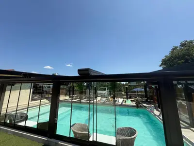 a view of the pool from the balcony of a hotel at DUNjA Apartman in Vrnjačka Banja