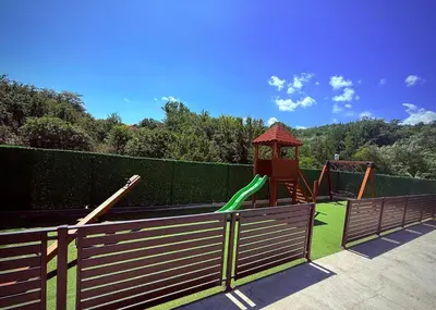 a playground with a slide and a gazebo at DUNjA Apartman in Vrnjačka Banja