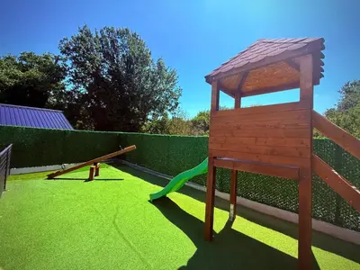 a play area with a playground with a swing at DUNjA Apartman in Vrnjačka Banja