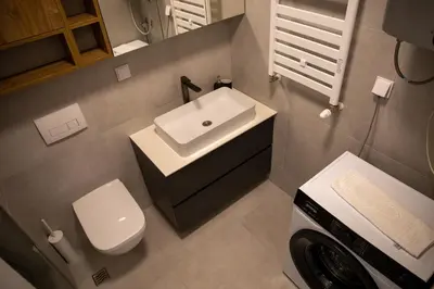 a small bathroom with a sink and a toilet at Planet Imperial Apartman & SPA in Niš