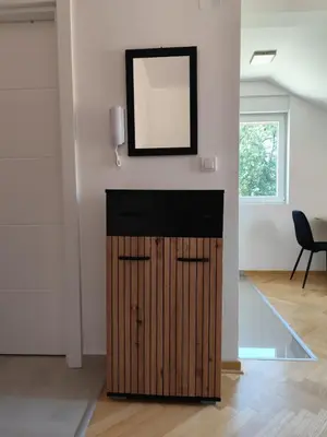 a mirror above a wooden door in a room at Raj M&M in Vrnjačka Banja
