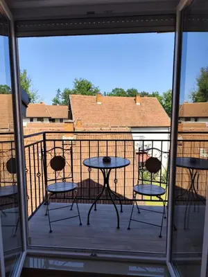 a balcony with four chairs and a table on a deck at Raj M&M in Vrnjačka Banja