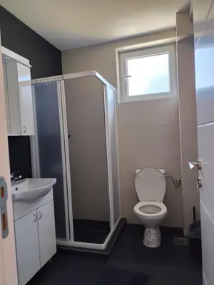 a bathroom with a shower and a toilet and a sink at Raj M&M in Vrnjačka Banja
