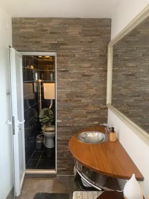 a bathroom with a wooden sink and a toilet at Kuća Sokolovića in Zaječar