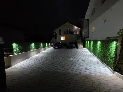 an empty street at night with green lights at L apartmani in Soko Banja