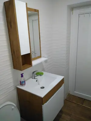 a bathroom with a sink and a mirror at Apartmani Lucky in Vrnjačka Banja