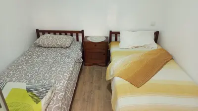 two beds sitting next to each other in a room at Apartmani Lucky in Vrnjačka Banja
