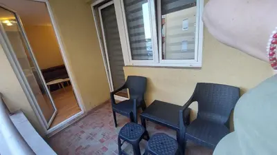 a room with two chairs and a table and a window at Apartman Dona in Jagodina