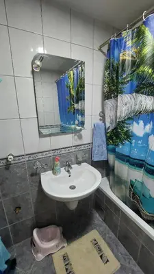 a bathroom with a sink and a mirror at Apartman Dona in Jagodina