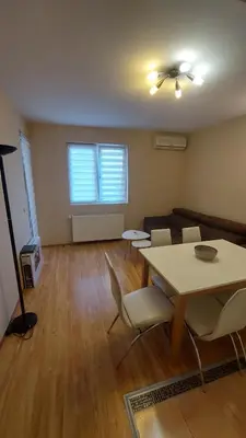 an empty living room with a table and chairs at Apartman Dona in Jagodina