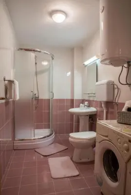 a bathroom with a shower and a toilet and a sink at Dvoristance in Vrnjačka Banja
