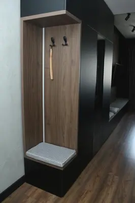 a wooden cabinet with a bench in a room at Urban Nest Nis in Niš