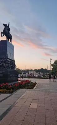 a statue of a man riding an elephant on top of a building at Urban Nest Nis in Niš
