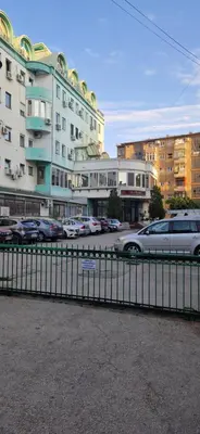 a car driving down a street next to buildings at Urban Nest Nis in Niš