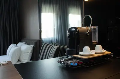 a coffee maker on a table in a hotel room at Urban Nest Nis in Niš
