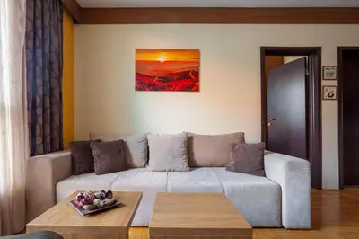 a living room with a couch and a table at HostGost at Kraljevi Čardaci in Kopaonik