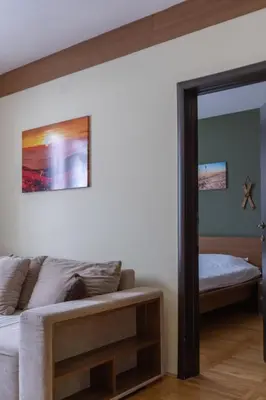 a bedroom with a bed and a mirror at HostGost at Kraljevi Čardaci in Kopaonik