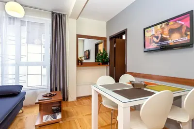 a living room with a table and a couch at HostGost at Kraljevi Čardaci in Kopaonik