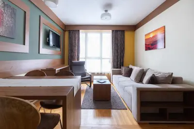 a living room with a couch and a table at HostGost at Kraljevi Čardaci in Kopaonik
