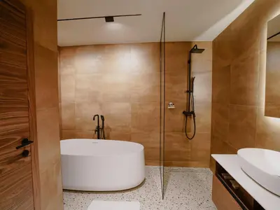 a bathroom with a white tub and a shower at Zyra boutique hotel in Leskovac