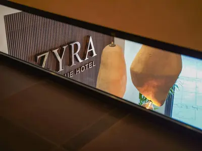 a tv screen with two vegetables on a shelf at Zyra boutique hotel in Leskovac