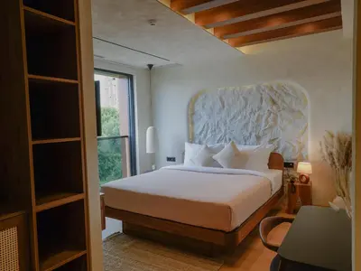 a bedroom with a bed with a large headboard at Zyra boutique hotel in Leskovac