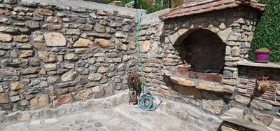 a bicycle is leaning against a stone wall at Vila Stara in Pakleštica