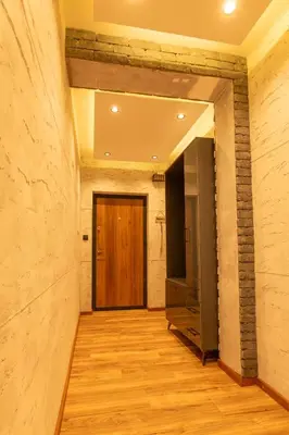 a hallway with a wooden door in a building at Ryo Golden Imperial 1 in Kruševac