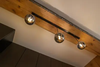 a row of lights hanging on a wall at Ryo Golden Imperial 1 in Kruševac