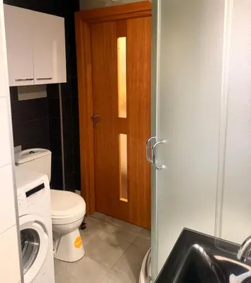 a small bathroom with a toilet and a sink at Natalie Apartment in Niš