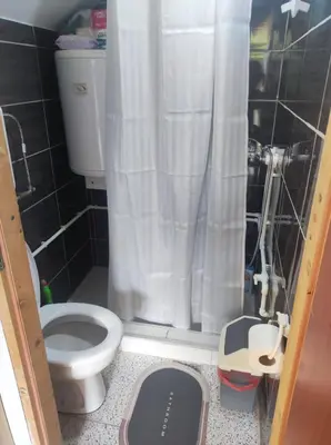 a bathroom with a toilet and a shower curtain at Konak Anja