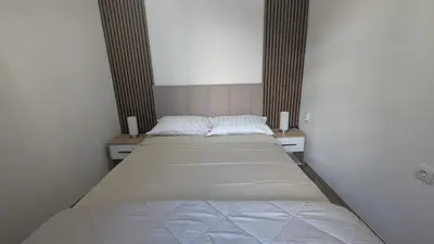 a bed in a room with two twin beds at Central House Niš in Niš