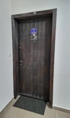 a large wooden door with a sign on it at Apartman Centar LUX in Vrnjačka Banja